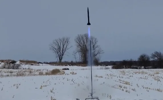 An EcoFusées 3D rocket launching in a snow-covered field